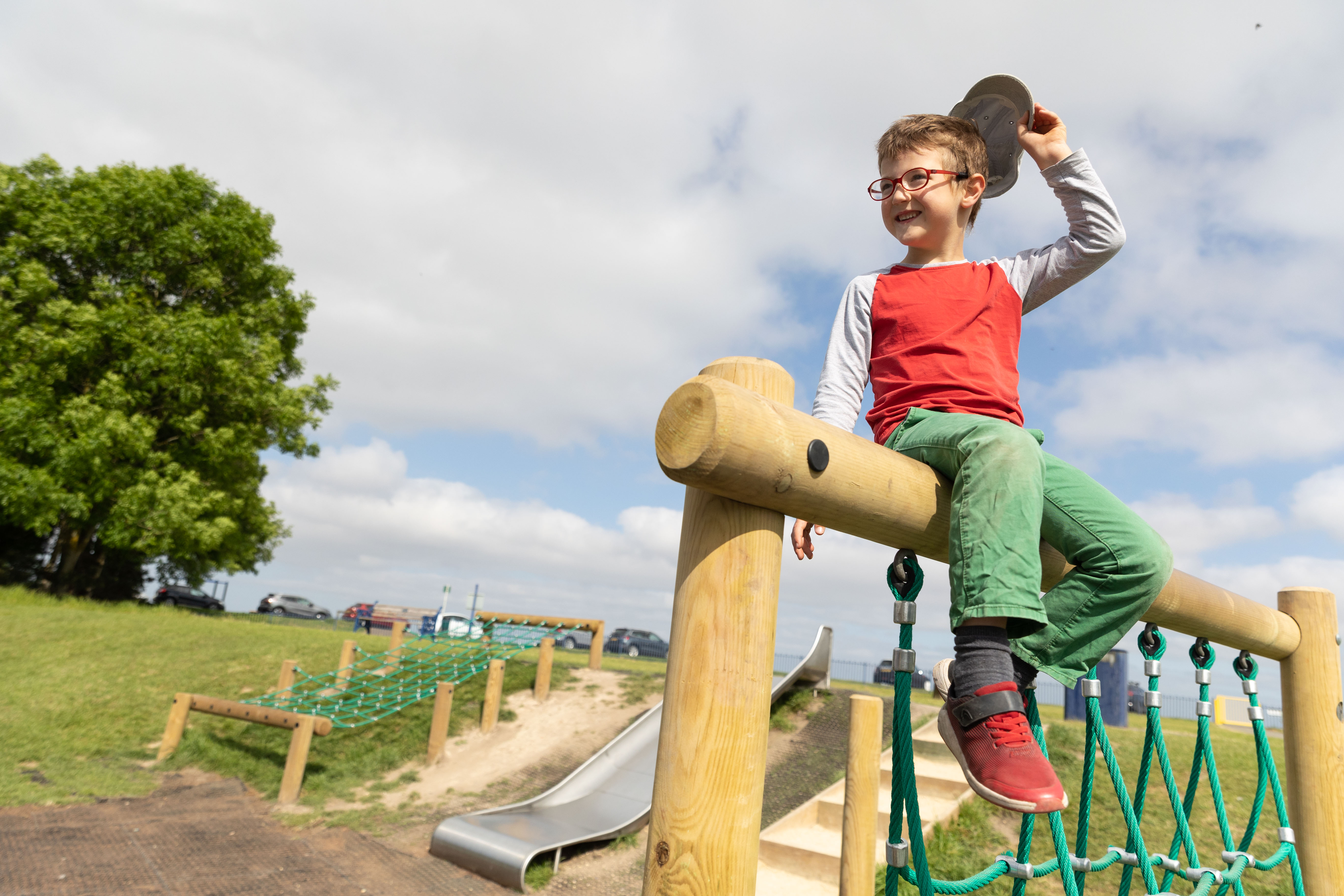 Child sitting on top of play equipment
