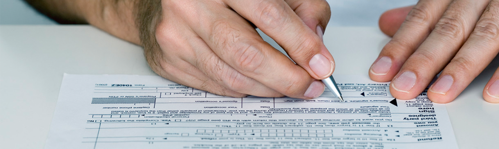 Financial support image of hands filling out a form