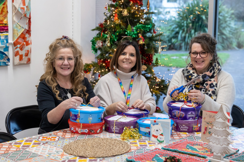 3 Ladies prepare hampers at a table