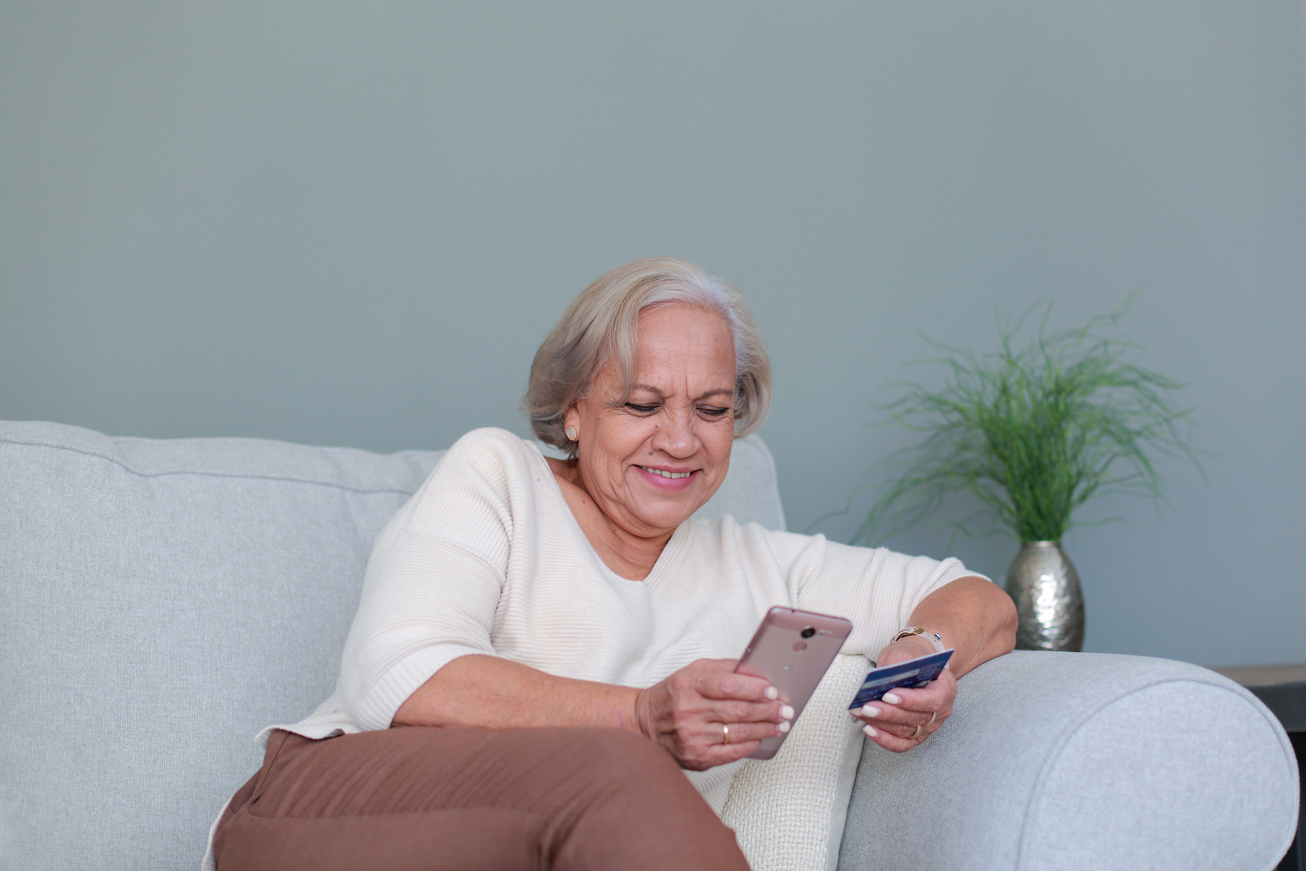 senior woman paying bill on phone