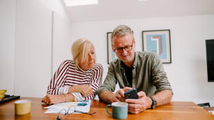 man and women looking at phone