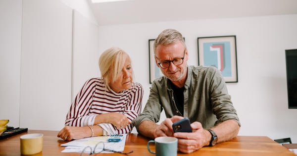 man and women looking at phone