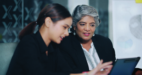 two women looking at laptop