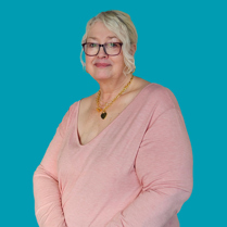 Angela, Customer Feedback Panel member, wearing a pink tshirt, gold necklace, glasses and standing against a teal backdrop.