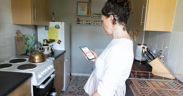 woman reporting repair on phone app