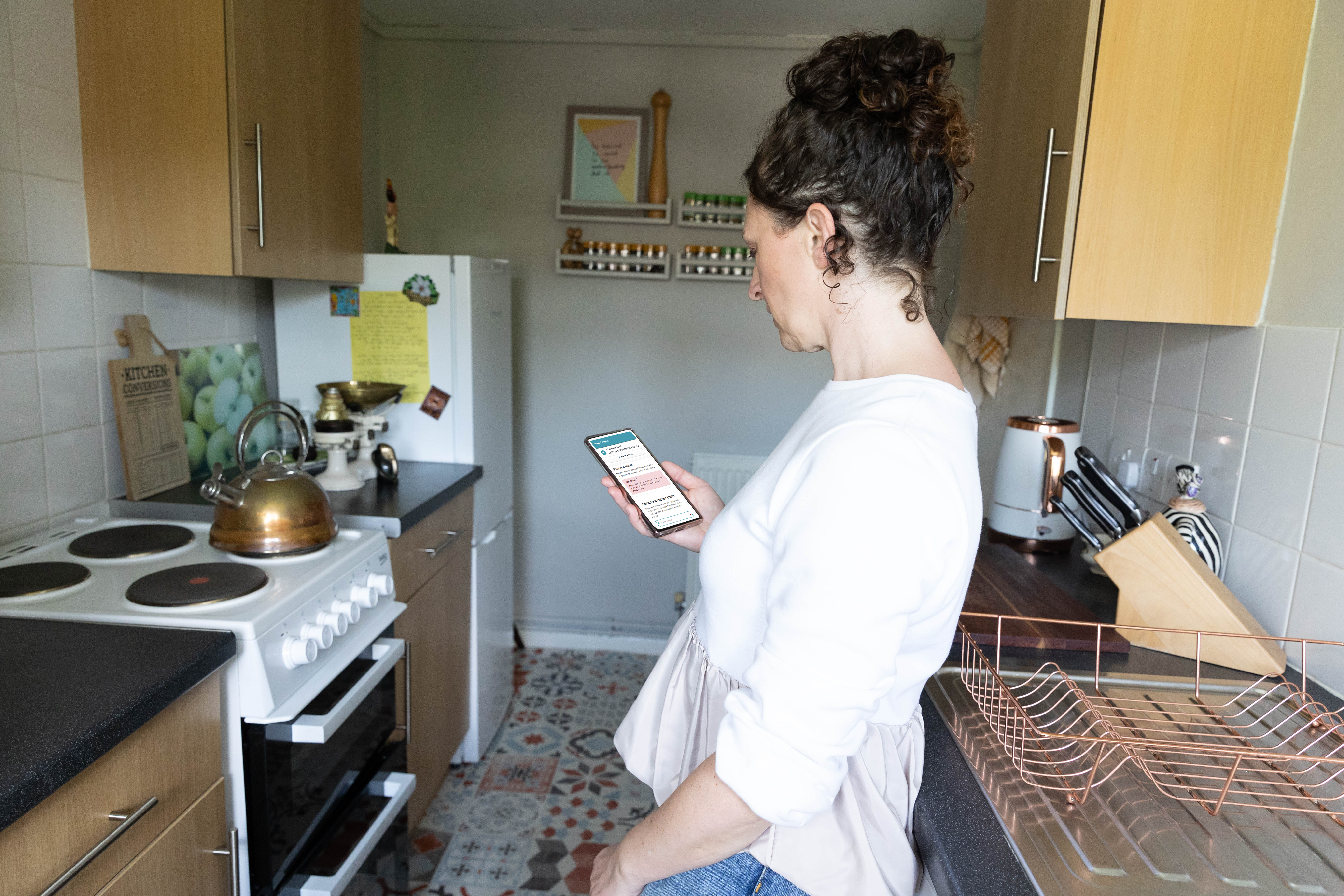 woman reporting repair on phone app