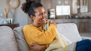 woman sat on couch at home