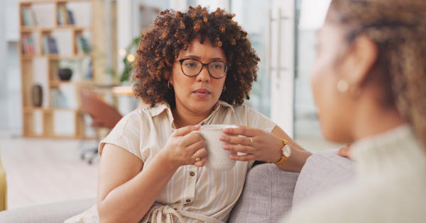 Woman with glasses drinking from cup