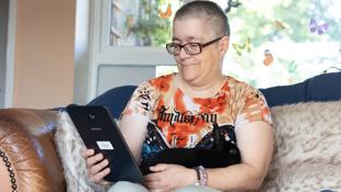 woman looking at phone with pet rabbit