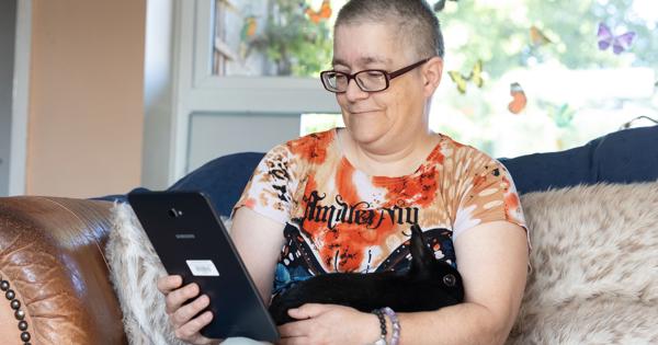 woman looking at phone with pet rabbit