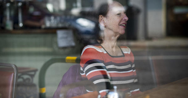 Lady At A Cafe Table