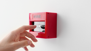 Hand about to press fire alarm