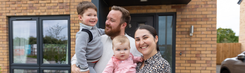 A family standing in front of their hourse